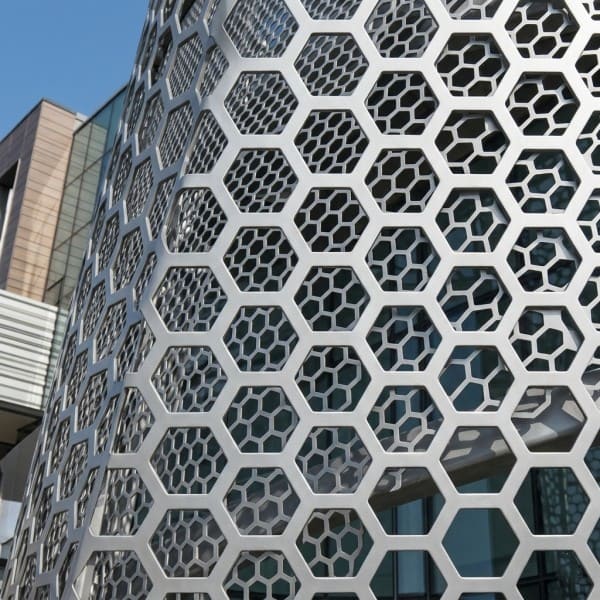 Aluminum mesh panels on building exterior screen